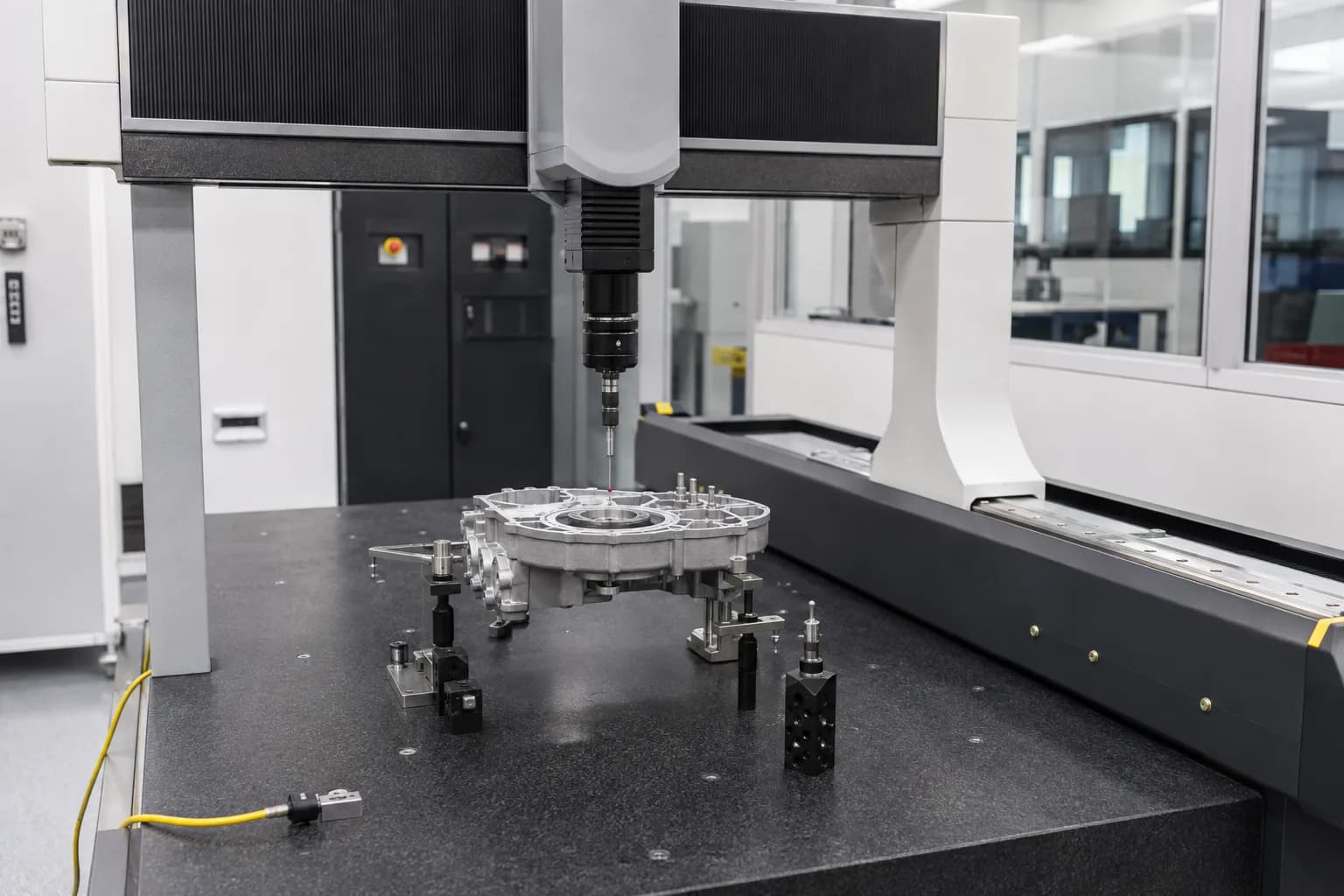 Coordinate measuring machine inspecting a machined component.